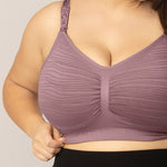 Close-up of a person wearing a twilight Sublime® Hands-Free Pumping & Nursing Bra on a neutral background