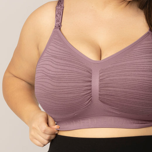 Close-up of a person wearing a twilight Sublime® Hands-Free Pumping & Nursing Bra on a neutral background