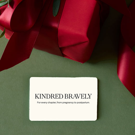 Gift wrapped in red with card reading Kindred Bravely - for every chapter, from pregnancy to postpartum, on green background