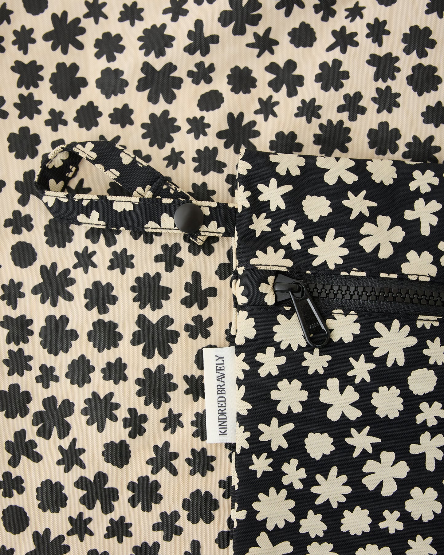 Close up of zipper and strap on Wet/Dry Bag Set in Cream Chamomiles on a beige background