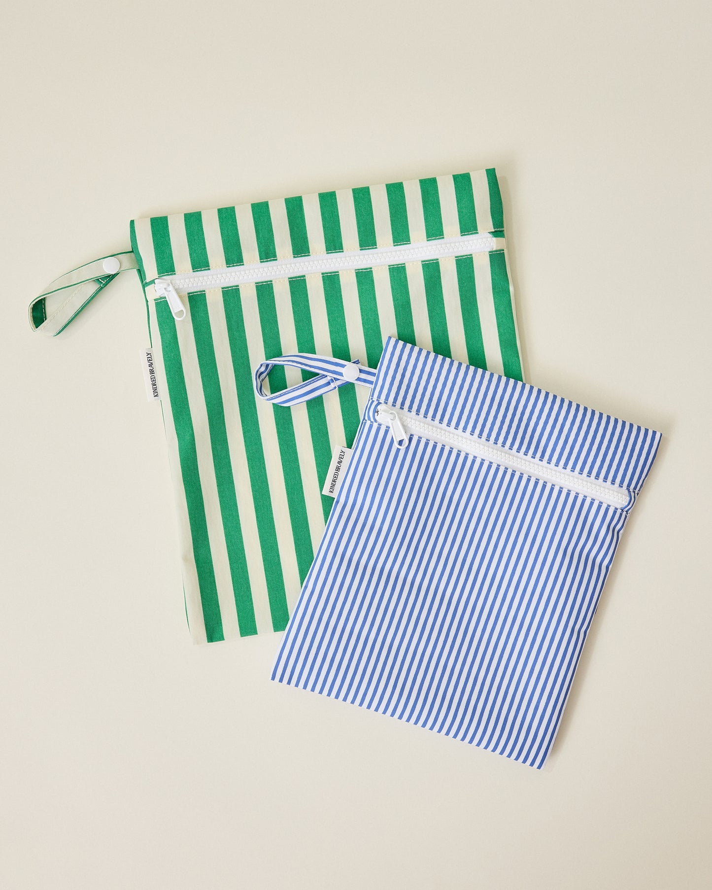 Wet/Dry Bag Set in Stripe print, one in wide green stripes and one in thin blue stripes, on beige background