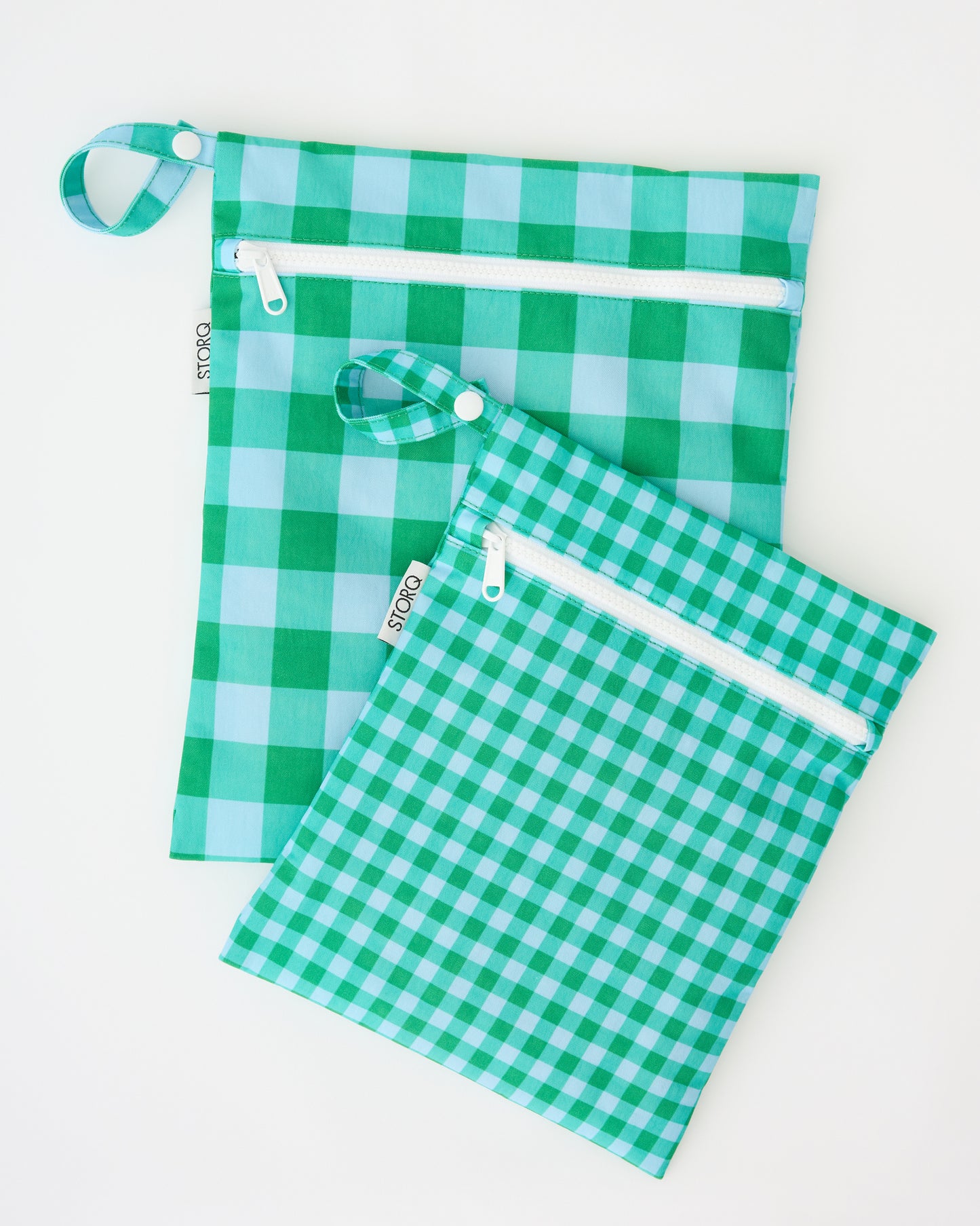 Wet/Dry Bag Set in Teal Gingham on a beige background. 
