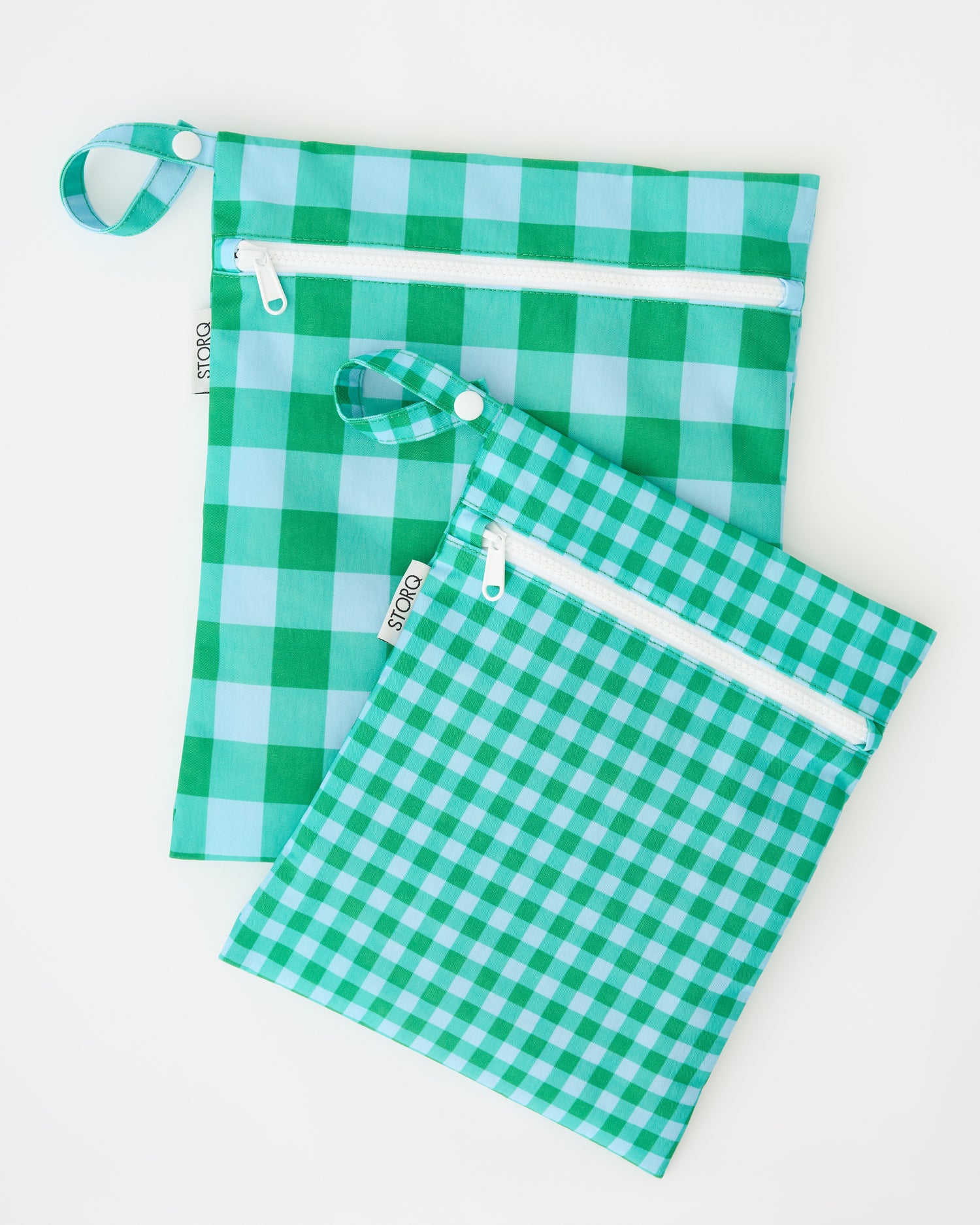 Wet/Dry Bag Set in Teal Gingham on a beige background. 