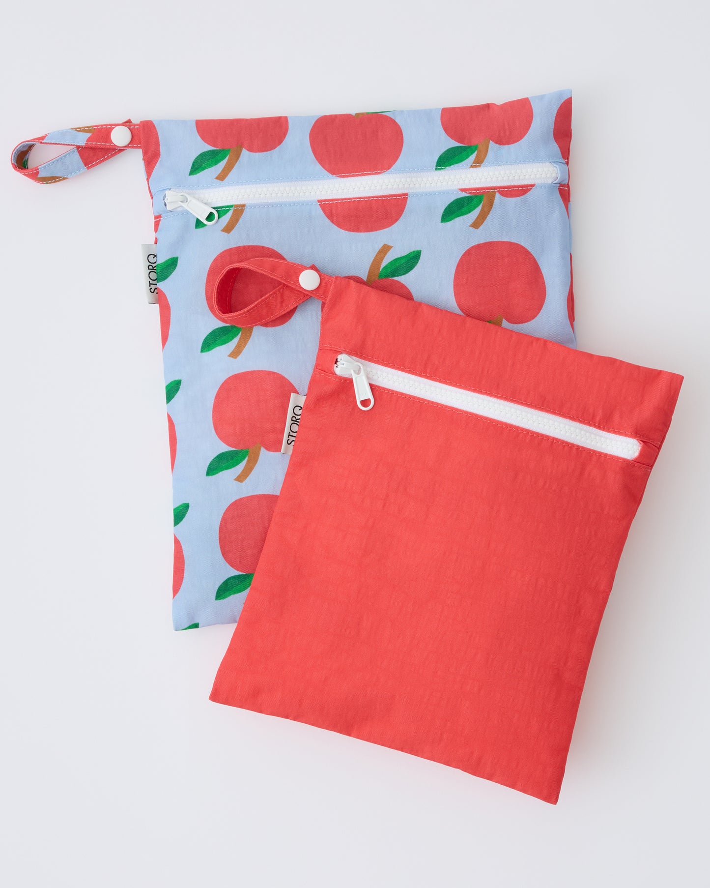 Wet/Dry Bag Set in Blue Apple on a beige background.