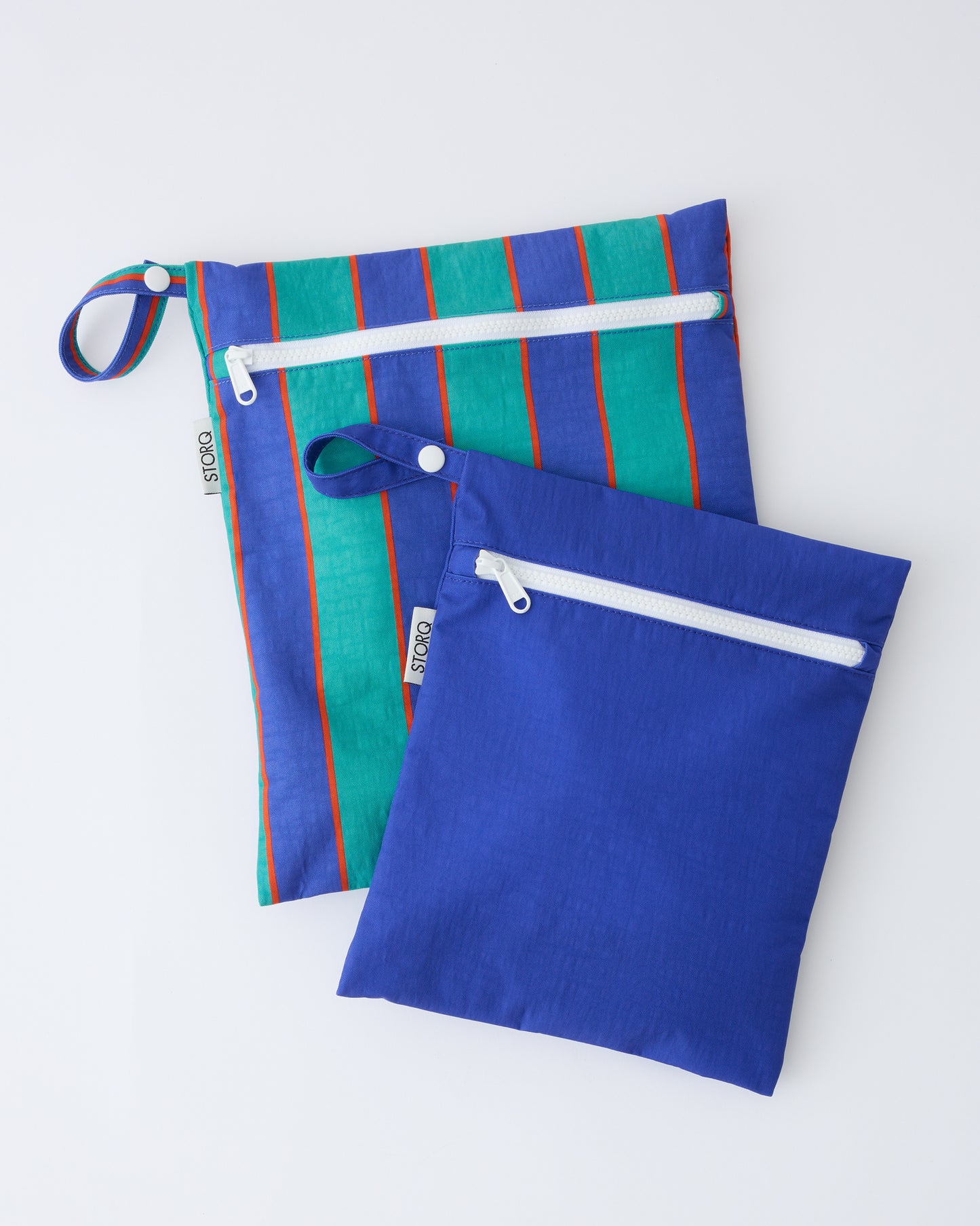 Wet/Dry Bag Set in Navy & Green Stripe on a beige background.