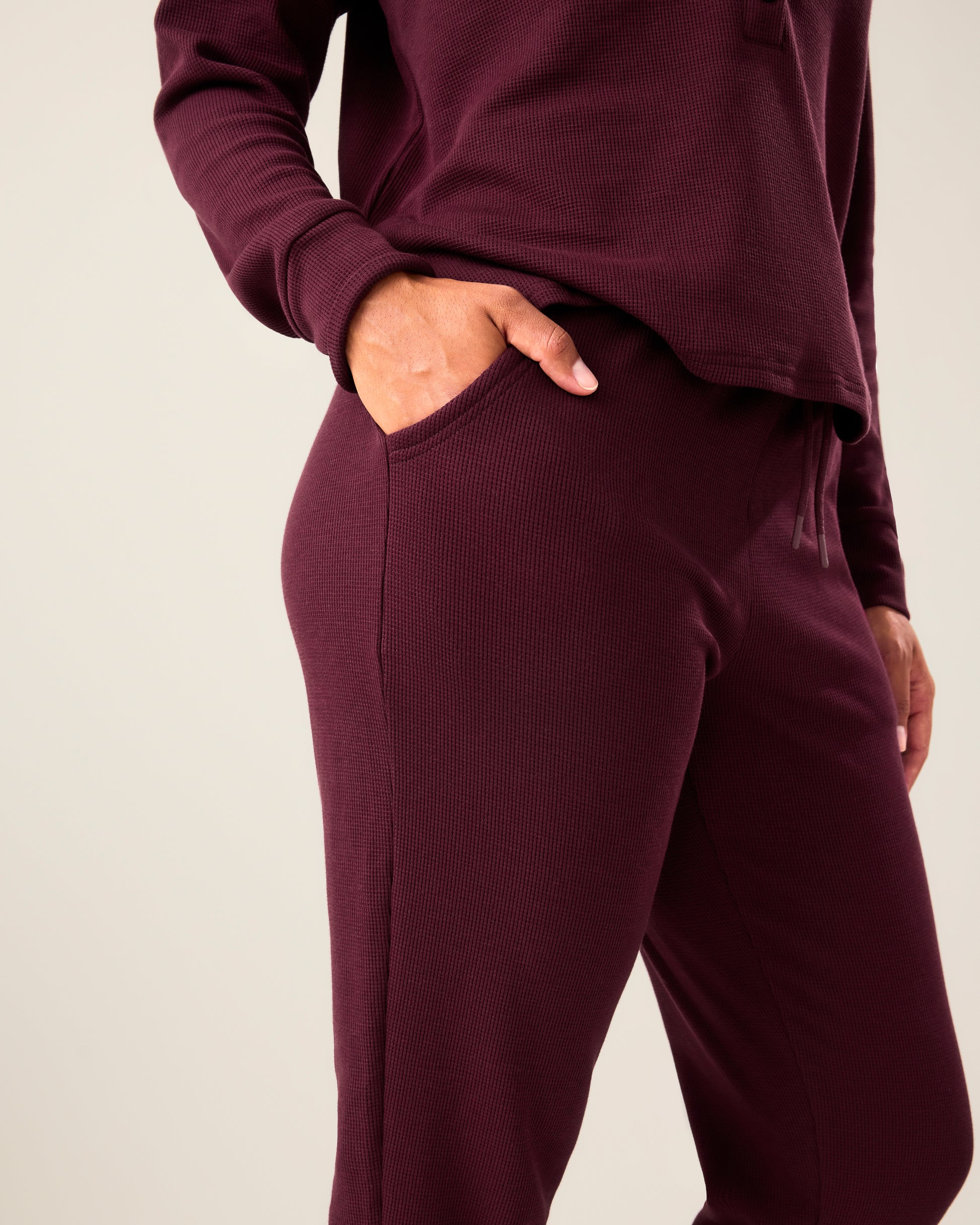 Close up of woman wearing the Waffle Maternity & Nursing Lounge Set in deep burgundy with hand in pocket