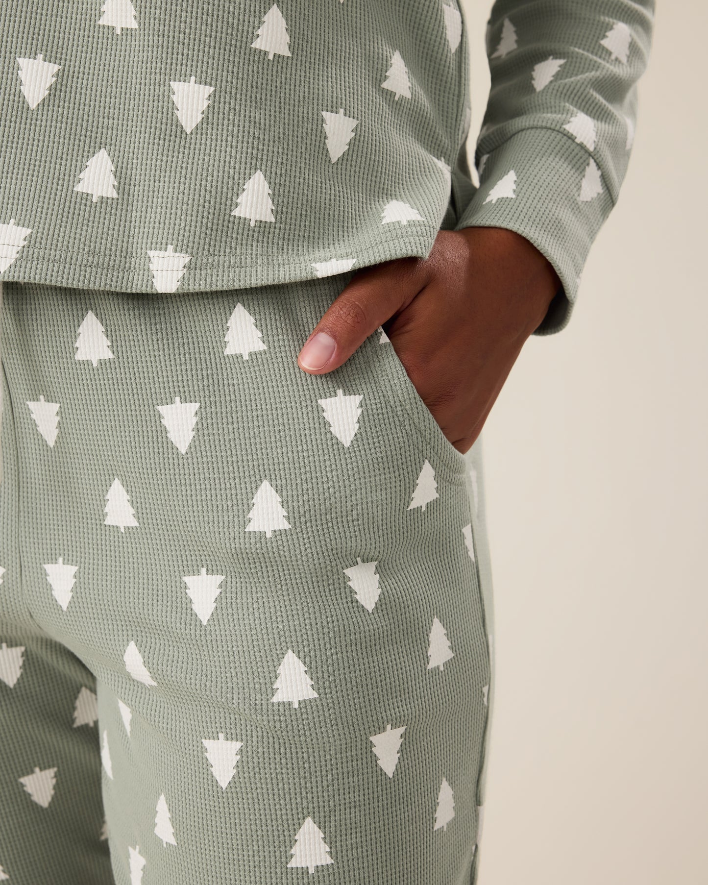 Close up of woman wearing the Waffle Maternity & Nursing Lounge Set in Sage Trees - sage green background with white tree pattern
