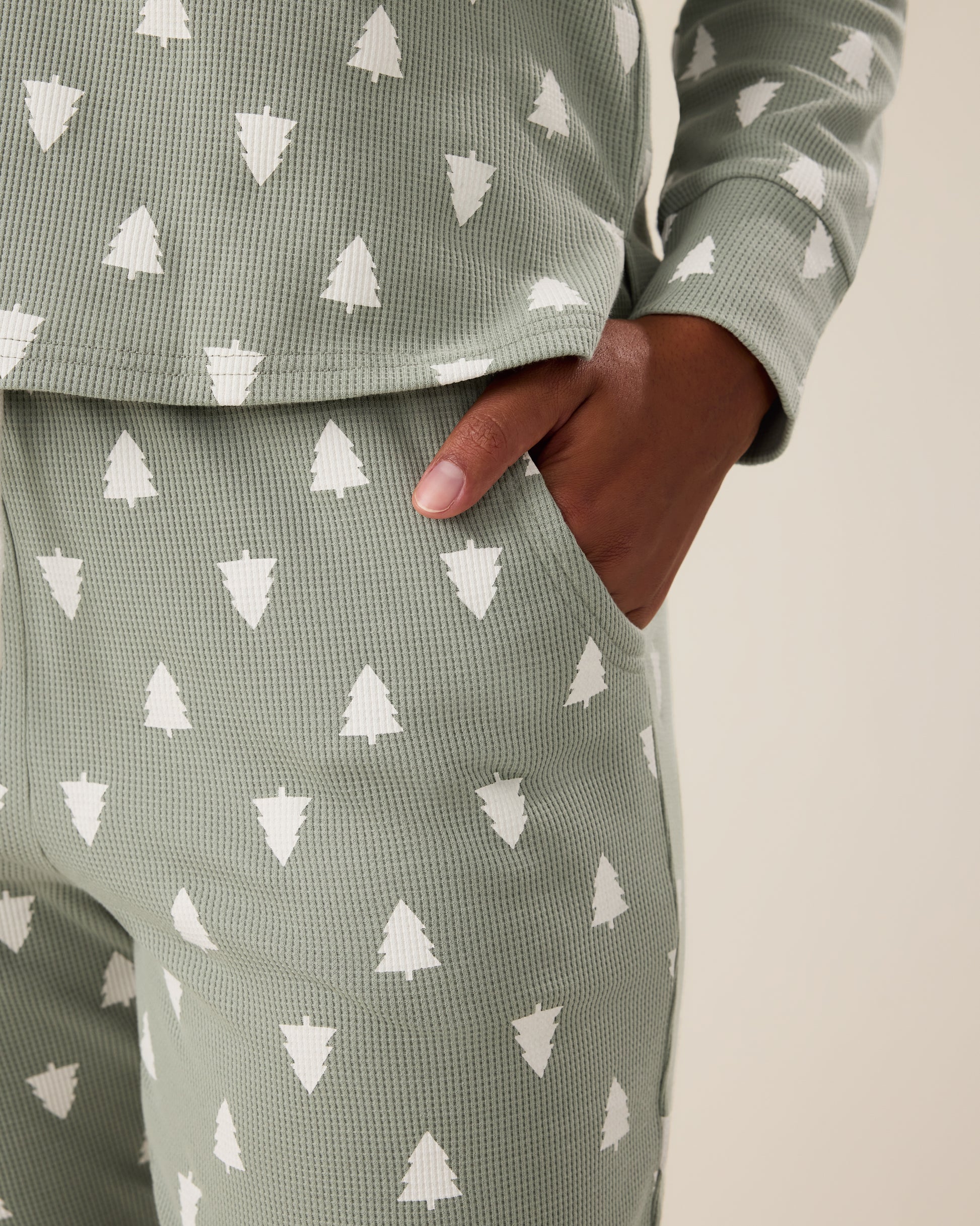 Close up of woman wearing the Waffle Maternity & Nursing Lounge Set in Sage Trees - sage green background with white tree pattern