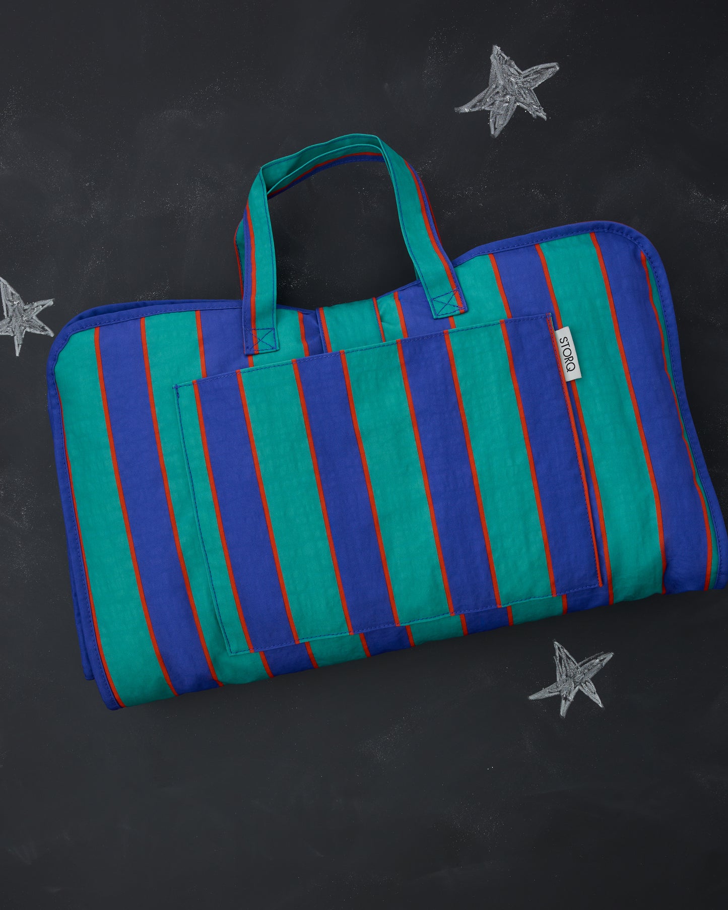 Cool Kid Nap Mat in Navy & Green Stripe on a blackboard background with chalk-drawn stars. 