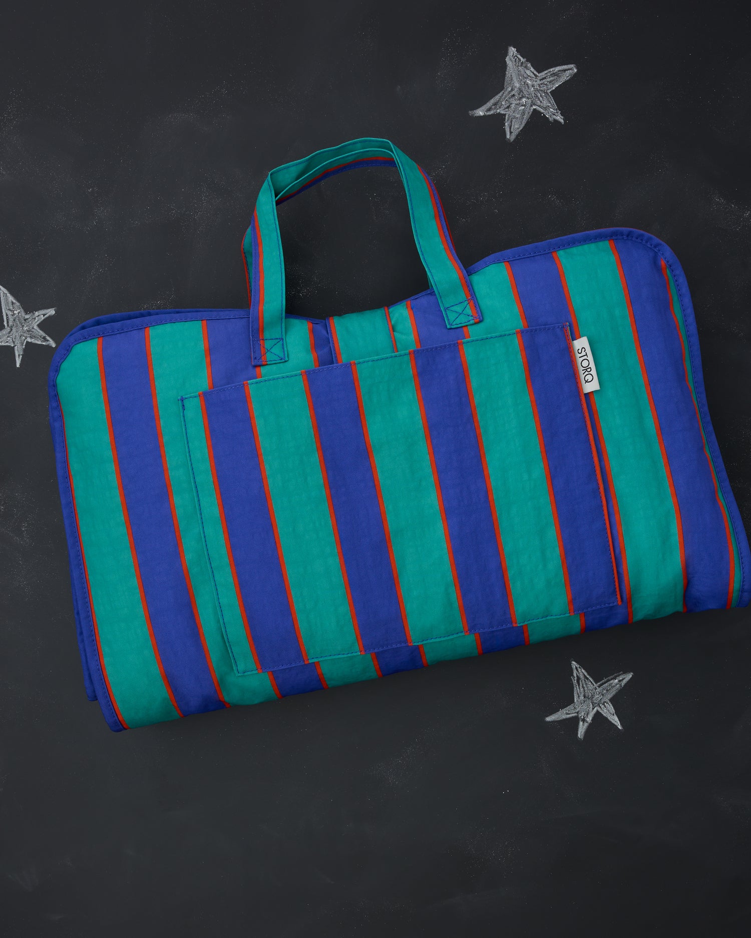 Cool Kid Nap Mat in Navy & Green Stripe on a blackboard background with chalk-drawn stars. 