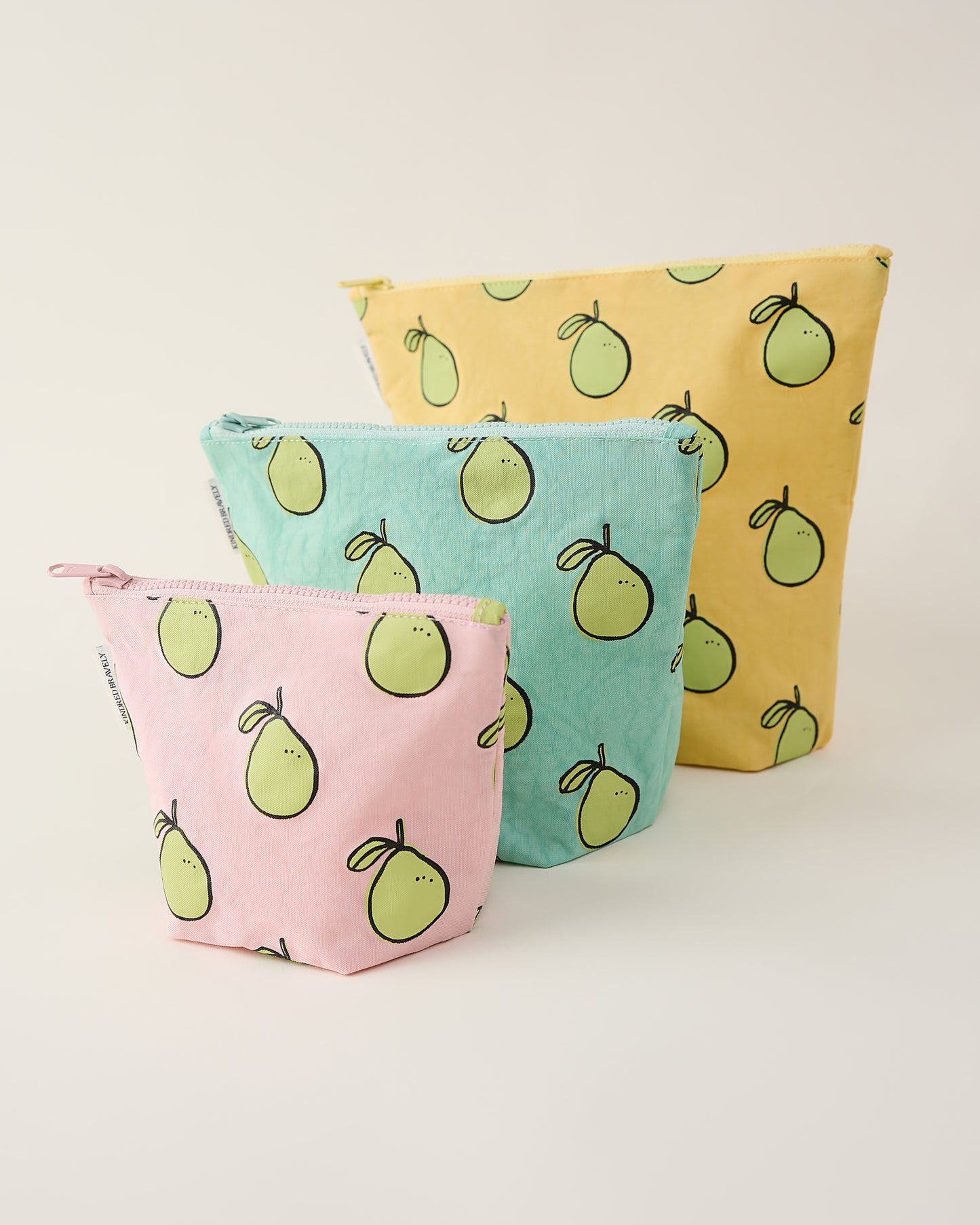 Three pouches with pomelo pattern on a light background