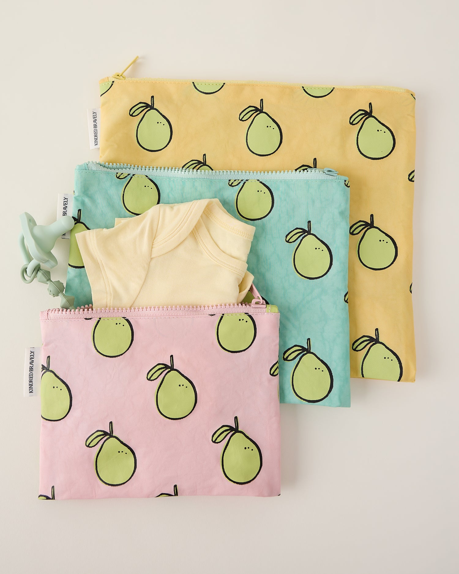 Three pouches with pomelo pattern on a light gray background
