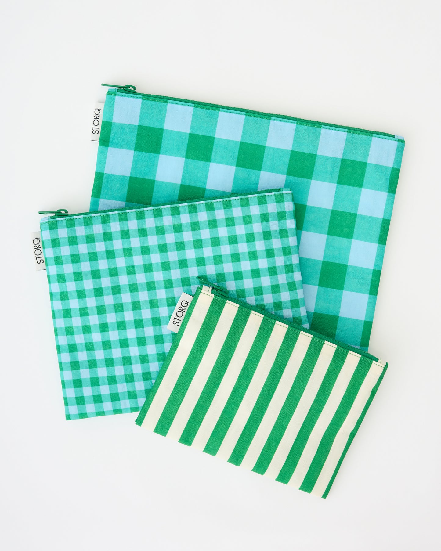 Zipper Pouch Three-Piece Set in Teal Gingham on a beige background.