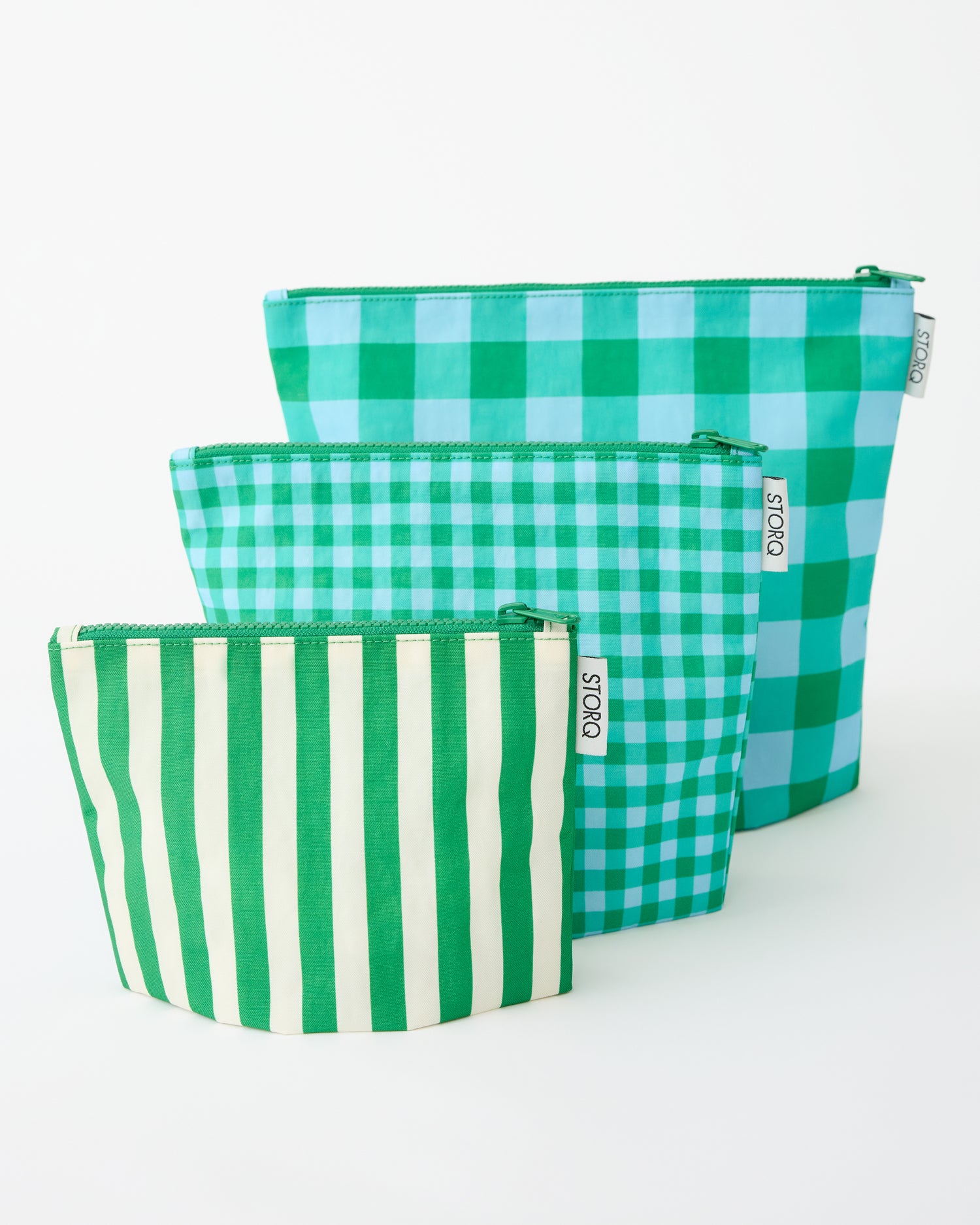 Zipper Pouch Three-Piece Set in Teal Gingham on a beige background.