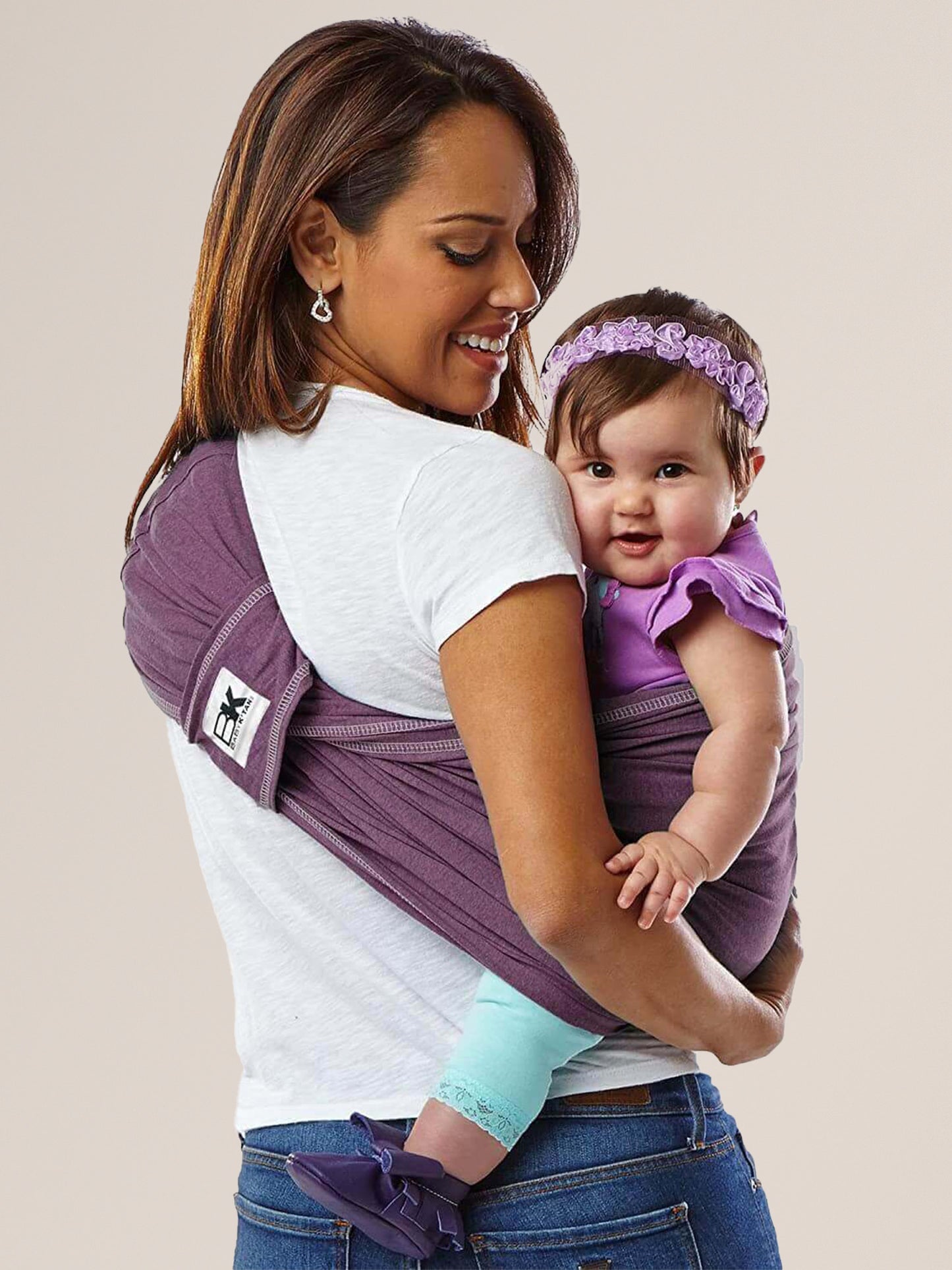 Model wearing baby in the Baby K'tan Original Baby Carrier in Eggplant