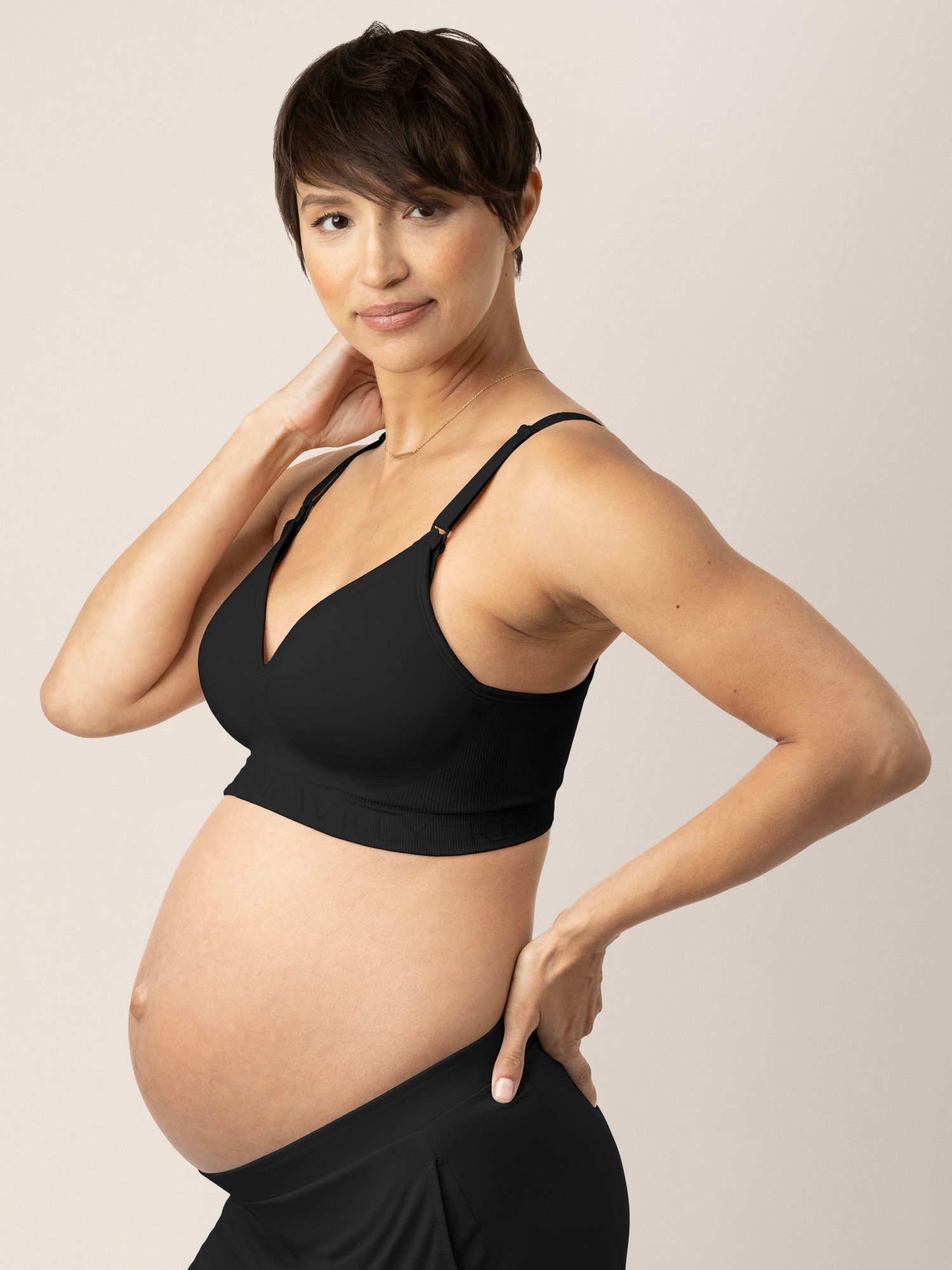 Side view of a pregnant model wearing the Signature Sublime® Contour Maternity & Nursing Bra in Black
