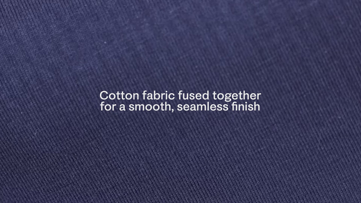 Load video: Short video of the stretchiness of the BareBond material, in Coastal Navy. White text reads, Cotton fabric fused together for a smooth, seamless finish.