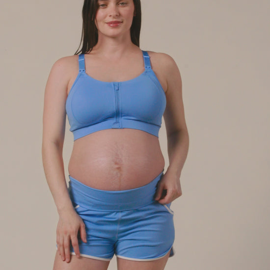Video of pregnant model showing fit on Active Maternity & Postpartum Short and High Impact Nursing Sports Bra in Harbor Blue on a beige background