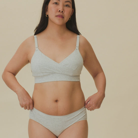 Video of model showing the soft fit of  SoftStretch Cotton Nursing Bra and SoftStretch Cotton Maternity & Postpartum Hipster in Grey Heather on a beige background. 