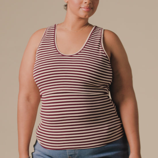 Video of model wearing Ribbed Bamboo Scoop Neck Nursing Tank in Garnet Stripe on a beige background.