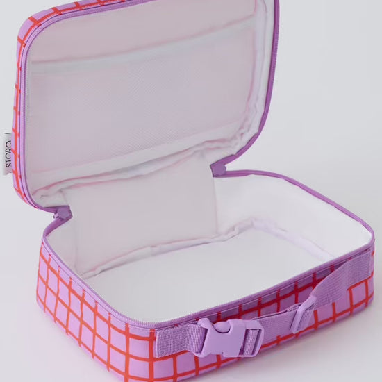 Video of six apples filling Cool Kid Lunch Box in Orchid Grid, on a beige background.