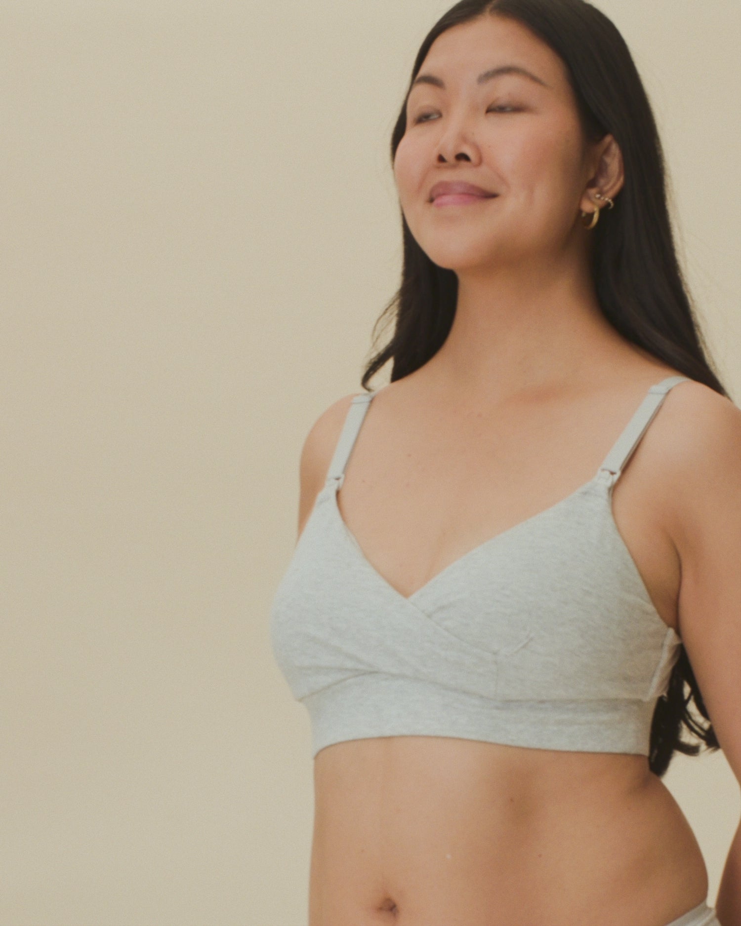 Video of model showing the fit on the SoftStretch Cotton Nursing Bra and SoftStretch Cotton Maternity & Postpartum Hipster in Grey Heather on a beige background. 