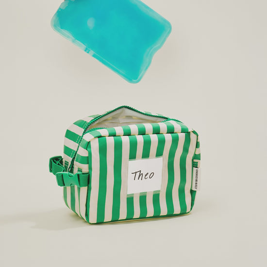 Stop motion video showing a cooler pad and milk being placed inside the Mini Cooler Bag in Green Stripe
