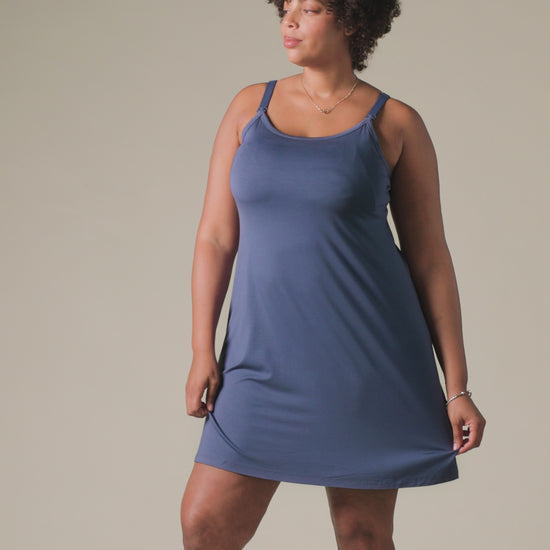 Video of model wearing Stella Hands-Free Pumping & Nursing Nightgown in Slate Blue, on a beige background.
