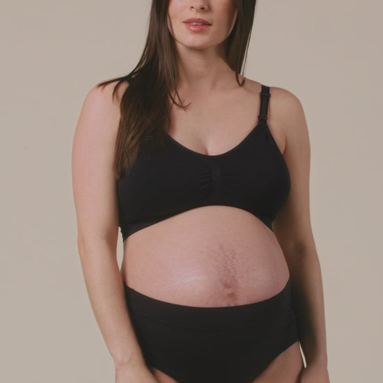 Video of Model displaying the fit on Grow with Me™ Maternity & Postpartum Brief in Black on a beige background