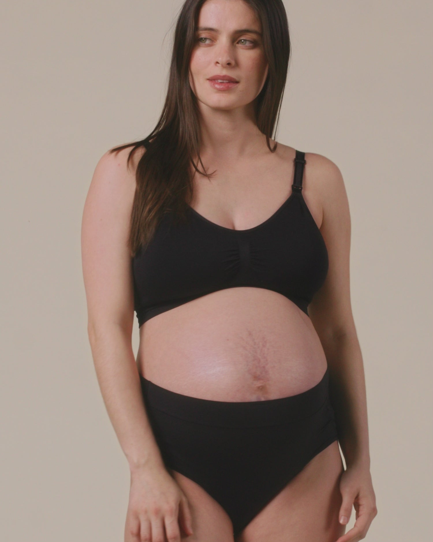 Video of Model displaying the fit on Grow with Me™ Maternity & Postpartum Brief in Black on a beige background