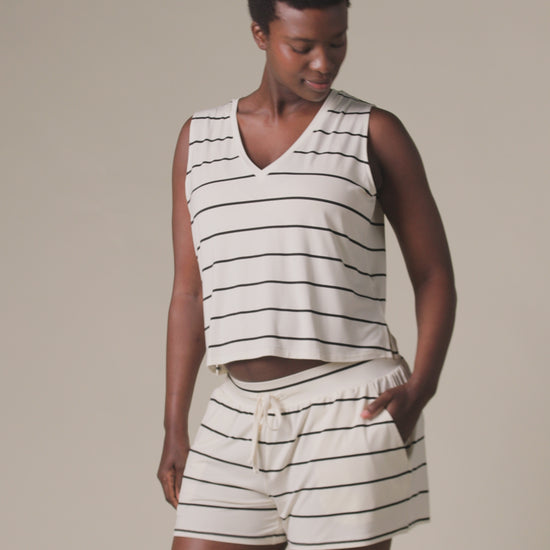 Video of model wearing Aria Bamboo Casual Lounge Short in Navy & White Stripe on a beige background.