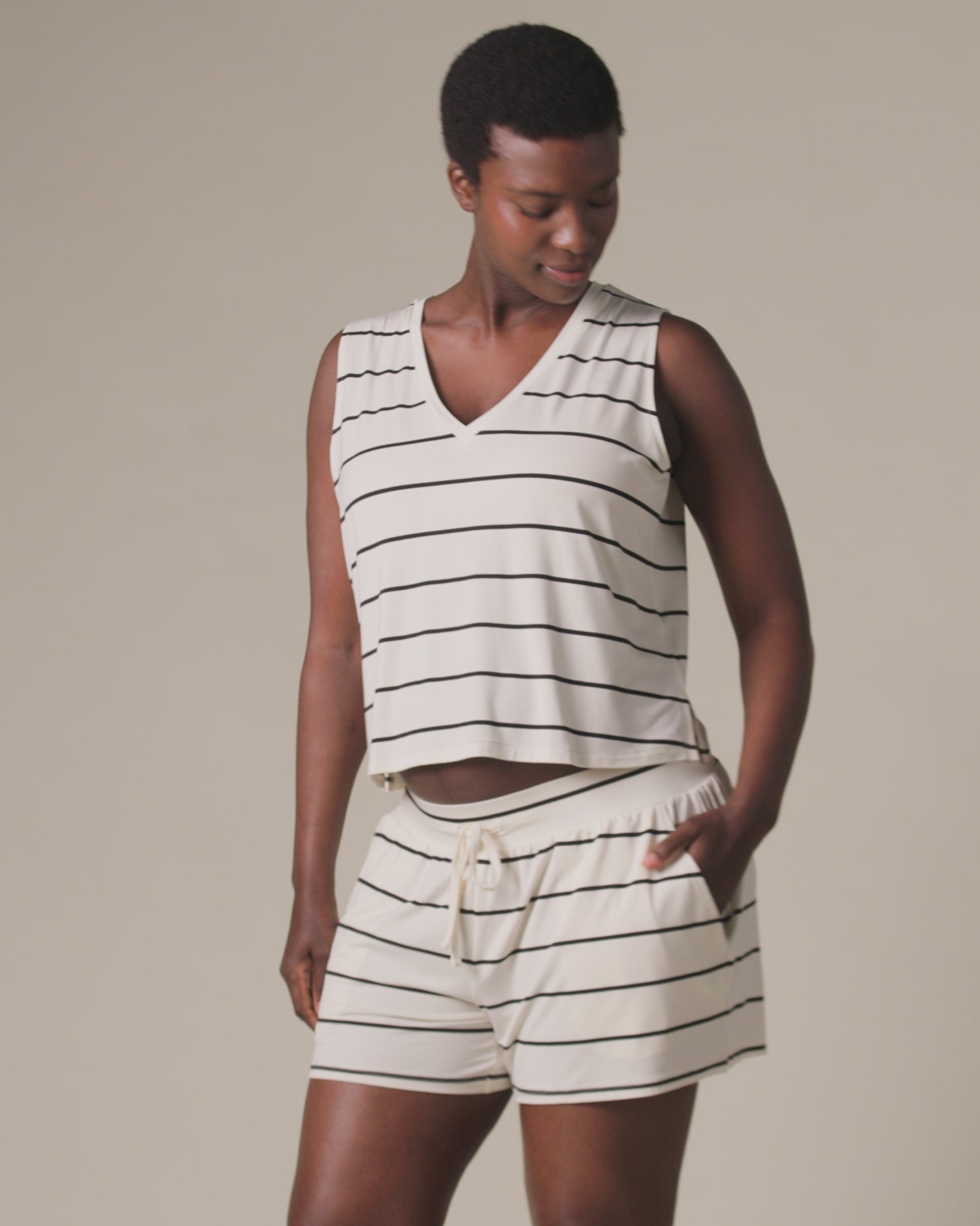 Video of model wearing Aria Bamboo Casual Lounge Short in Navy & White Stripe on a beige background.