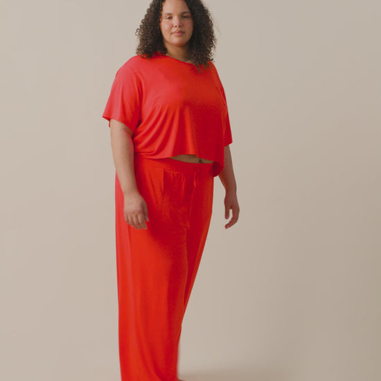 Video of model wearing Aria Short Sleeve Cropped Top on a neutral background