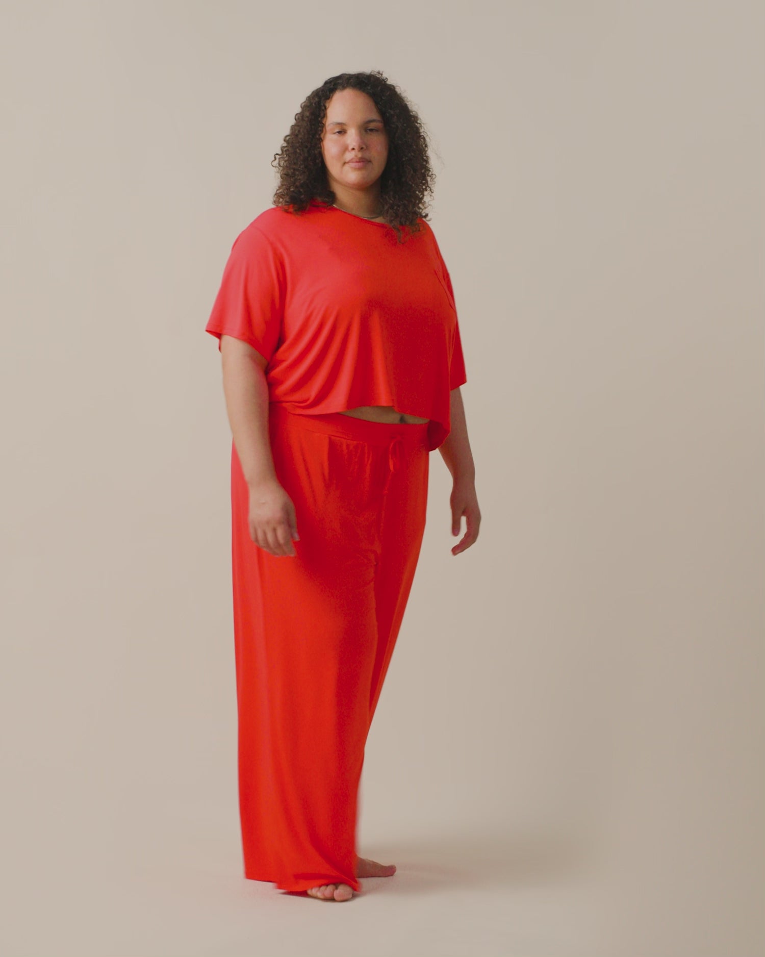 Video of model wearing Aria Short Sleeve Cropped Top on a neutral background