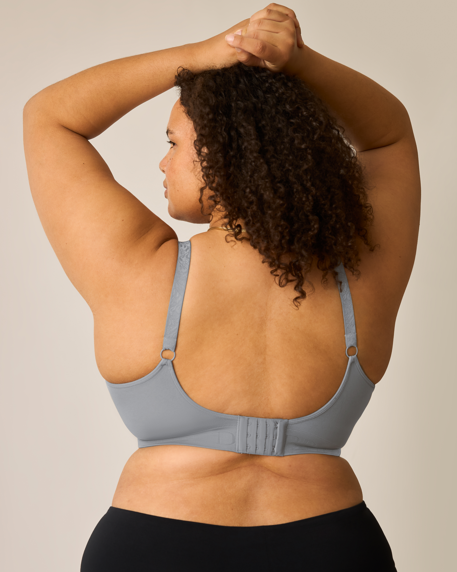 Woman wearing the Simply Sublime® Nursing Bra in grey on a neutral background