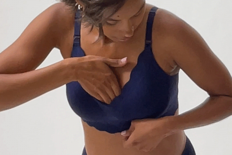 Gif of model adjusting and stretching Bare Bond™ Cotton Maternity & Nursing Bra in Coastal Navy, on a beige background.