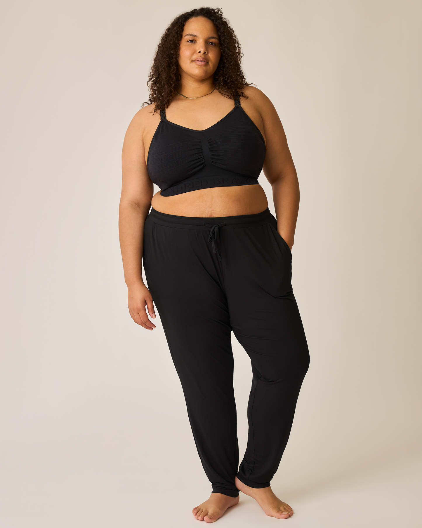 Woman wearing the Everyday Lounge Jogger in Black with matching bra@model_info:Ionna is 5'11" and wearing a 2X Long.
